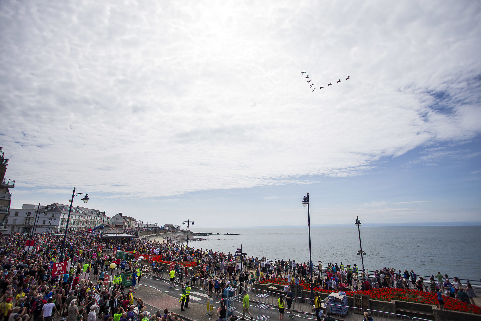 A crowd gathers at Porthcawl seafront to watch a flypast.