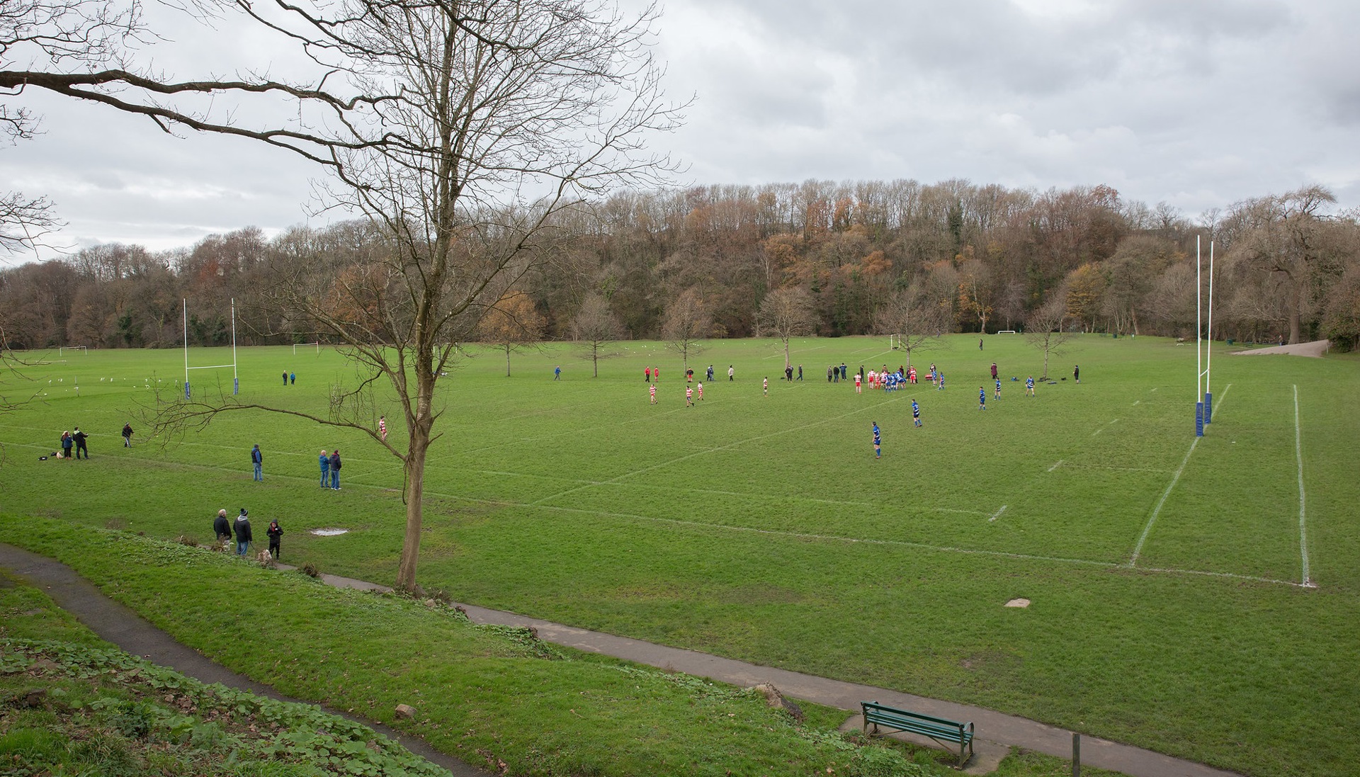 A sports pitch with people playing on it.