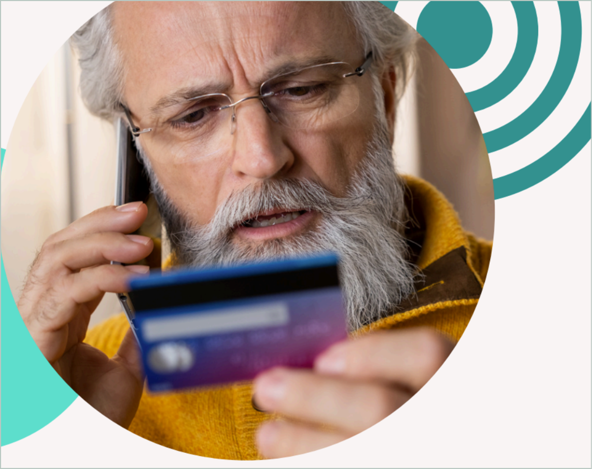 Man on phone looking at a payment card