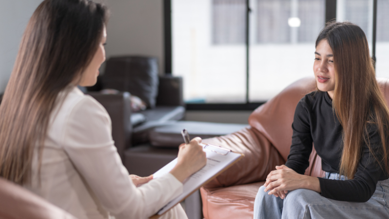 Woman and teenager sitting down and talking