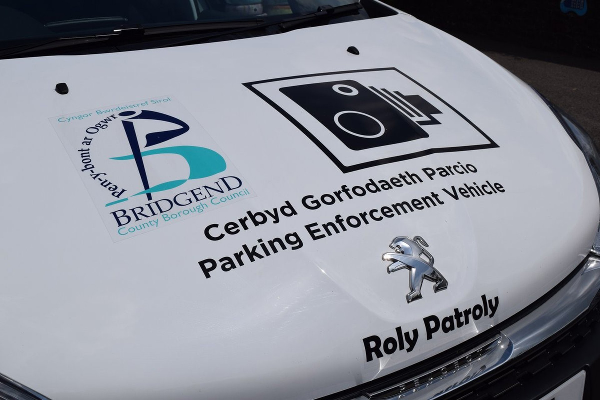 The front bonnet of patrol car ‘Roly Patroly’ which shows the council’s logo, a traffic camera sign and the words ‘Parking Enforcement Vehicle’.