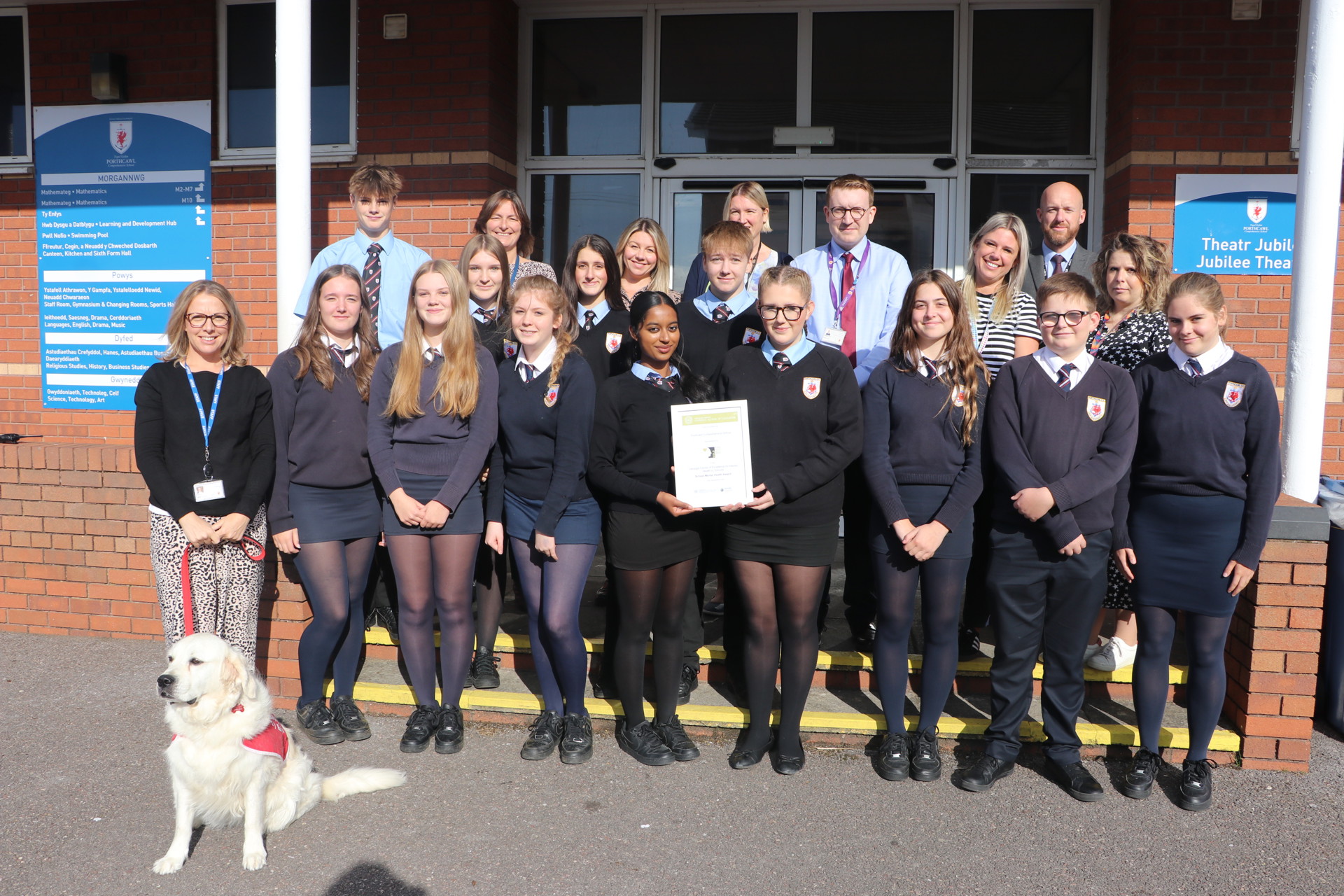 Pupils and staff pose with award