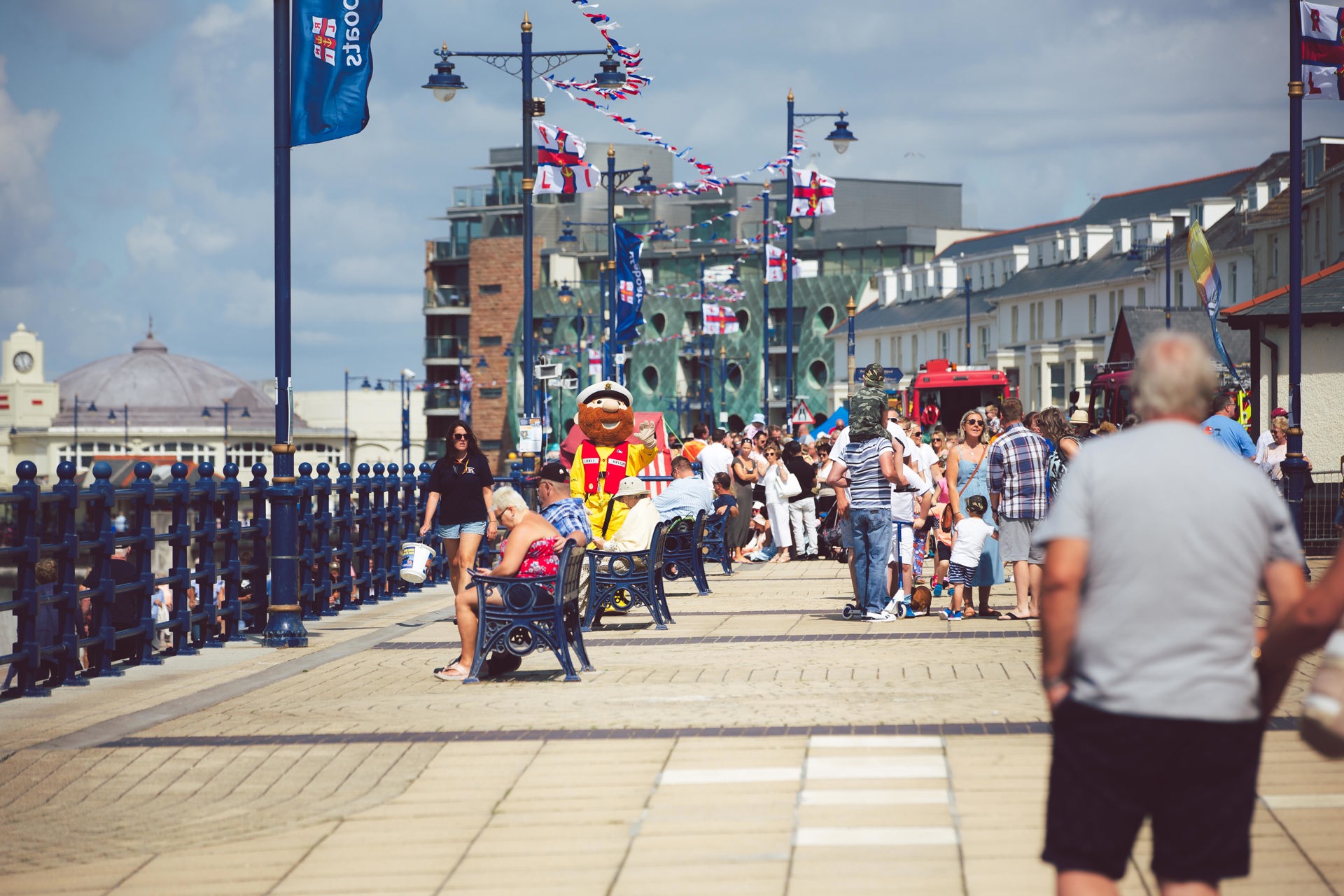 A crowd mingles among the promenade in Porthcawl.